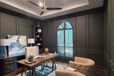 Home office - mid-sized transitional dark wood floor and brown floor home office idea in Dallas with black walls
