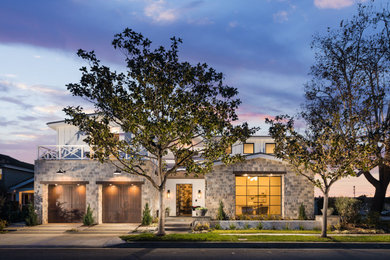 Large country white two-story concrete fiberboard exterior home photo in Orange County with a metal roof