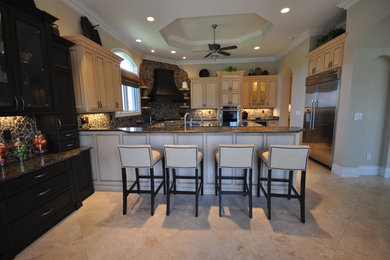 Eat-in kitchen - large transitional u-shaped travertine floor eat-in kitchen idea in Miami with an undermount sink, recessed-panel cabinets, light wood cabinets, quartz countertops, brown backsplash, stone tile backsplash, stainless steel appliances and an island