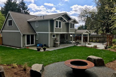Large craftsman green two-story concrete fiberboard exterior home idea in Seattle with a shingle roof