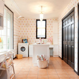 Classic utility room with recessed-panel cabinets, white cabinets, multi-coloured walls, terracotta flooring, orange floors and white worktops.