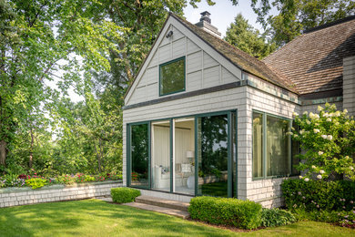 Mid-sized contemporary beige one-story exterior home idea in Minneapolis with a tile roof and a brown roof