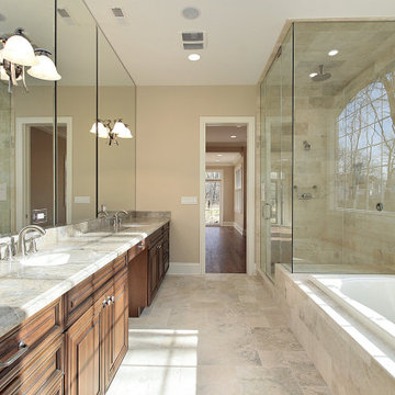 Master Bathroom With Bathtub and Attached Shower, Wall Mirror and Wall Lamps