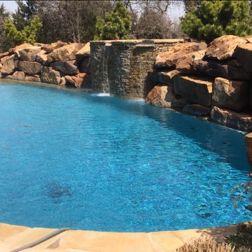 Custom Pool with Beach Entry and Large Waterfall
