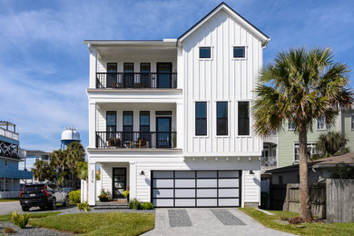 Example of a country white three-story house exterior design in Jacksonville