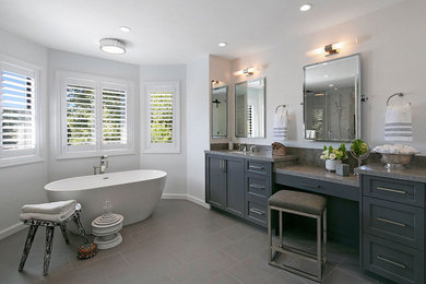 Bathroom - large transitional master beige tile and marble tile porcelain tile, gray floor and double-sink bathroom idea in San Francisco with recessed-panel cabinets, gray cabinets, a one-piece toilet, white walls, an undermount sink, quartz countertops, a hinged shower door, multicolored countertops and a built-in vanity
