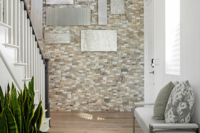 Example of a mid-sized transitional medium tone wood floor foyer design in Los Angeles