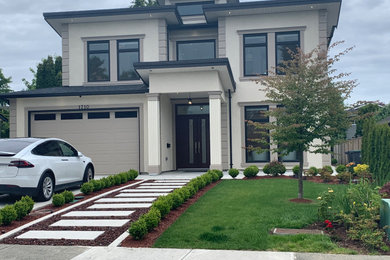 Mid-sized trendy beige two-story stucco house exterior photo in Vancouver with a shingle roof and a gray roof