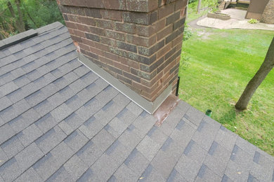 Inspiration for a mid-sized gray split-level mixed siding and clapboard exterior home remodel in Minneapolis with a shingle roof and a gray roof