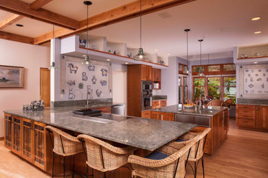 Eat-in kitchen - large u-shaped exposed beam eat-in kitchen idea in Seattle with an undermount sink, raised-panel cabinets, medium tone wood cabinets, granite countertops, granite backsplash, stainless steel appliances, an island and green countertops