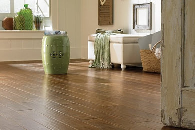 Example of a mid-sized cottage chic formal and enclosed medium tone wood floor and brown floor living room design in Orange County with beige walls, no fireplace and no tv