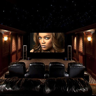 Example of a large minimalist enclosed carpeted and multicolored floor home theater design in Atlanta with multicolored walls and a projector screen