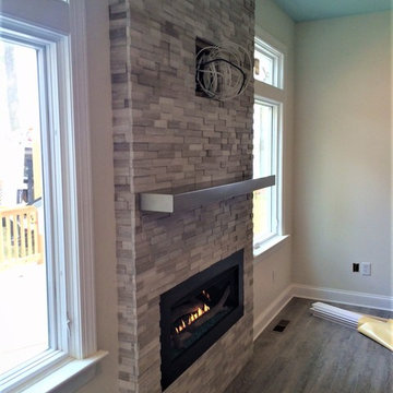 New Linear Gas fireplace & Stacked Stone on Blank Wall.....Magic Make Over
