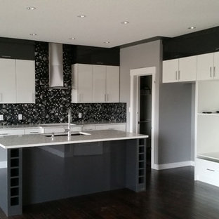 Large contemporary kitchen pantry appliance - Large trendy l-shaped dark wood floor kitchen pantry photo in Edmonton with an undermount sink, flat-panel cabinets, white cabinets, solid surface countertops, black backsplash, mosaic tile backsplash and an island