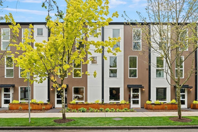 Inspiration for a modern beige three-story flat roof remodel in Seattle