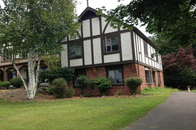 Example of a mid-sized two-story mixed siding gable roof design in Orange County