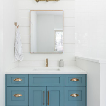 Blue Bathroom Vanity with Brass Lighting – Lake Cabin Carriage House Conversion,
