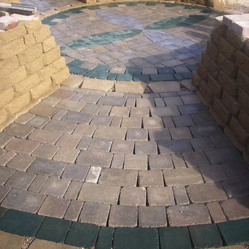 Custom Stained Paver Patio Surrounded By Raised Gardens