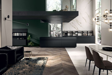 Photo of a large contemporary u-shaped kitchen/diner in Other with an integrated sink, black cabinets, composite countertops, black appliances, an island and black worktops.