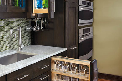 Inspiration for a craftsman medium tone wood floor and brown floor kitchen remodel in New York with a single-bowl sink, shaker cabinets, dark wood cabinets, green backsplash, stainless steel appliances, marble countertops and mosaic tile backsplash