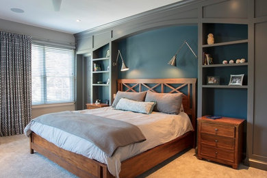 This is an example of a large transitional master bedroom in DC Metro with blue walls, carpet and beige floor.