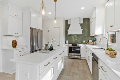 Eat-in kitchen - huge transitional u-shaped eat-in kitchen idea in DC Metro with a drop-in sink, shaker cabinets, white cabinets, green backsplash, subway tile backsplash, stainless steel appliances and an island