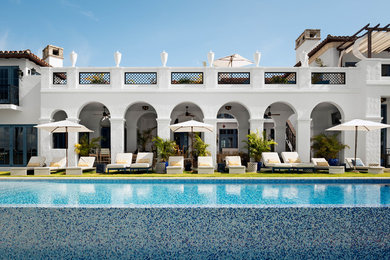 Inspiration for a mediterranean white two-story exterior home remodel in Miami