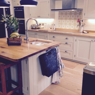 Traditional cream, handmade kitchen with wooden worktops and statement tiles