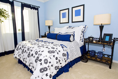 Photo of a mid-sized country guest bedroom in DC Metro with blue walls, carpet, no fireplace and beige floor.