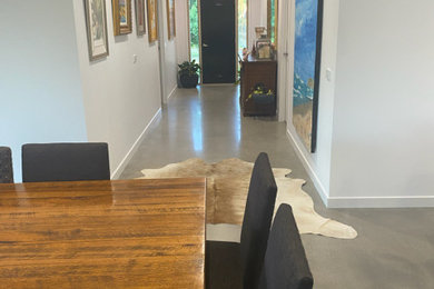 Mid-sized trendy concrete floor and gray floor hallway photo in Melbourne with white walls