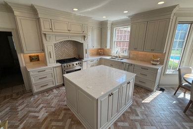 Example of a large classic l-shaped beige floor eat-in kitchen design in Other with an undermount sink, raised-panel cabinets, white cabinets, quartz countertops, subway tile backsplash, stainless steel appliances, an island and white countertops