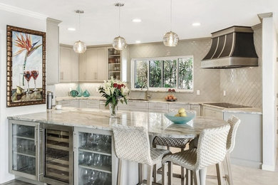 Example of a classic beige floor kitchen design in Other with granite countertops, a peninsula, an undermount sink, recessed-panel cabinets, beige cabinets and beige backsplash