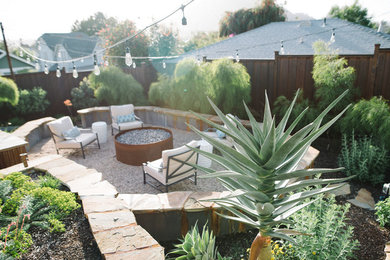 Mid-sized southwest backyard gravel patio photo in San Luis Obispo with a fire pit and no cover
