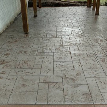 J-Stamped concrete patio with a step under the wood deck