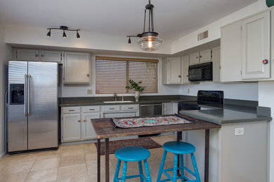 Kitchen - eclectic porcelain tile kitchen idea in Phoenix with raised-panel cabinets, gray cabinets, quartz countertops and an island