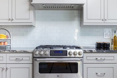 Inspiration for a mid-sized transitional galley light wood floor and beige floor eat-in kitchen remodel in Dallas with an undermount sink, shaker cabinets, gray cabinets, quartzite countertops, beige backsplash, glass tile backsplash, stainless steel appliances and an island