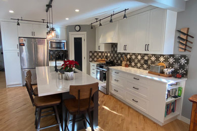 Example of a transitional kitchen design in Calgary