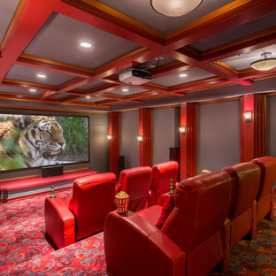 Example of a classic enclosed carpeted and red floor home theater design in Seattle with gray walls and a projector screen