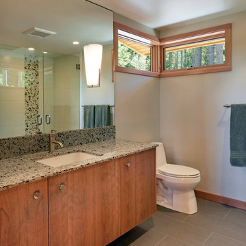 The second bathroom features vertical grain cherry vanity and quartz countertop.