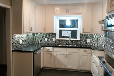 Mid-sized elegant galley slate floor eat-in kitchen photo in Austin with an undermount sink, shaker cabinets, white cabinets, granite countertops, multicolored backsplash, subway tile backsplash, stainless steel appliances and no island