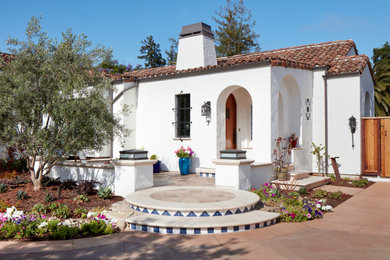 Mid-sized tuscan white one-story stucco exterior home photo in San Francisco with a tile roof and a red roof