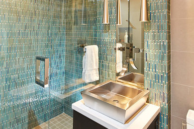Mid-sized trendy 3/4 gray tile and ceramic tile porcelain tile bathroom photo in San Diego with flat-panel cabinets, dark wood cabinets, a one-piece toilet, gray walls, a vessel sink and quartz countertops