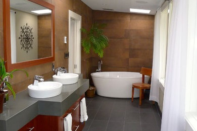 Bathroom - modern master brown tile and porcelain tile porcelain tile and gray floor bathroom idea in Vancouver with flat-panel cabinets, dark wood cabinets and granite countertops