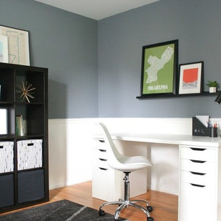 Design ideas for a medium sized modern craft room in Philadelphia with blue walls, medium hardwood flooring, no fireplace, a freestanding desk and brown floors.