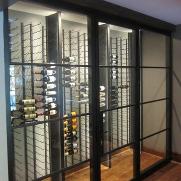 Glass Walls and Metal Custom Wine Racks Create a Contemporary Wine Cellar