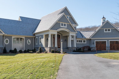 Large traditional gray two-story wood house exterior idea in Bridgeport with a shingle roof