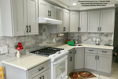 Eat-in kitchen - mid-sized modern l-shaped ceramic tile and white floor eat-in kitchen idea in New York with a single-bowl sink, shaker cabinets, gray cabinets, quartz countertops, gray backsplash, ceramic backsplash, white appliances, an island and white countertops
