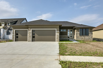 Inspiration for a large contemporary brown one-story stone house exterior remodel in Other with a shingle roof