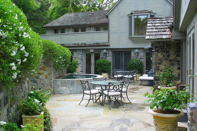 Photo of an expansive arts and crafts backyard patio in San Francisco with a vertical garden and natural stone pavers.