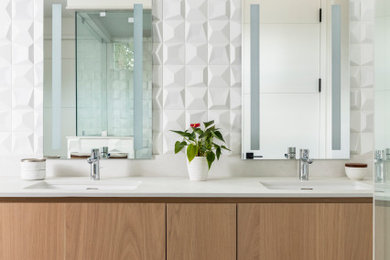 Example of a trendy gray floor and double-sink bathroom design in Denver with flat-panel cabinets, medium tone wood cabinets, white walls, an undermount sink, white countertops and a floating vanity